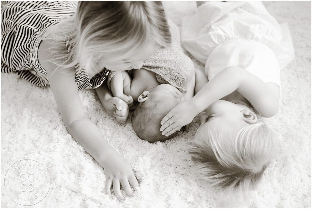 newborn with sisters